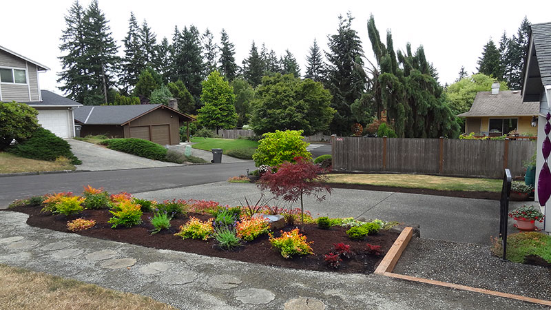 Easy-care plantings and the new crushed gravel path direct visitors to the front door.